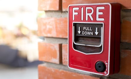 fire alarm pull box on brick wall